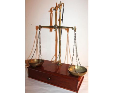 A mahogany and brass beam balance, marked Class B, with pan scales