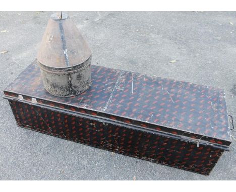 A late 19thC/early 20thC metal travel trunk, former property of Lord Hesketh, in black with red highlights, with flush carryi