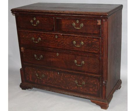 An 18thC oak chest, of two short and three long drawers, with a wide over hanging moulded top flanked by quarter columns on c