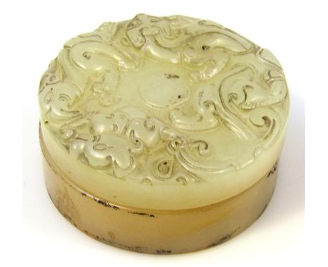 A 20thC Chinese jade box, of circular outline, carved with scrolls and flower heads, with removable lid and plain interior, 6