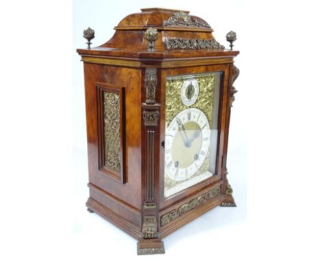 A late Victorian figured walnut bracket clock, with gilt metal adornments, canted Ionic columns and a German eight-day moveme