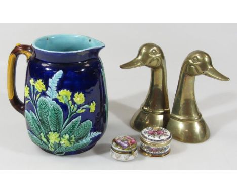 A 19thC majolica jug, of typical outline with bark work handle raised with flowers predominantly in yellow, turquoise and gre