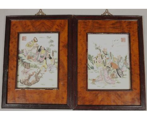 A pair of Chinese porcelain panels, each polychrome decorated with figures, one attacking tiger, etc., on a grassy knoll, wit