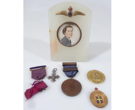 An RAF related portrait miniature, of a lady officer, quarter profile, probably gouache on ivory, in marble case with silver 