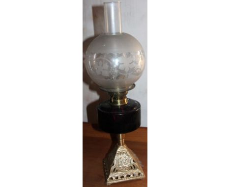 A Victorian cast metal and glass oil lamp