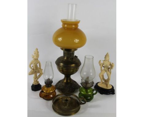 An oil lamp, two nightlights, a pair of erotic figures and brass chamberstick