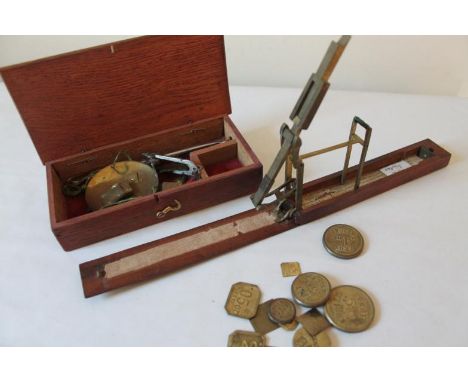 A set of Georgian brass and mahogany pocket sovereign scales, and a variety of troy ounce penny weights, and a small cased ba