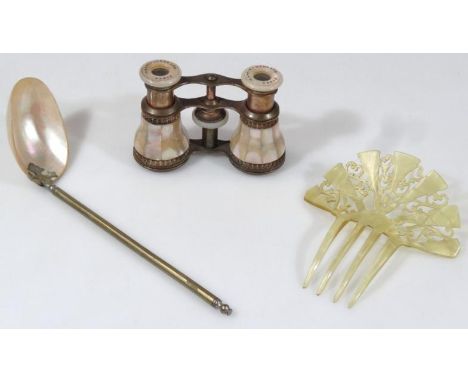 An early 20thC hair clip, possibly plastic and a mother of pearl and metal serving ladle, 22cm high, together with a pair of 