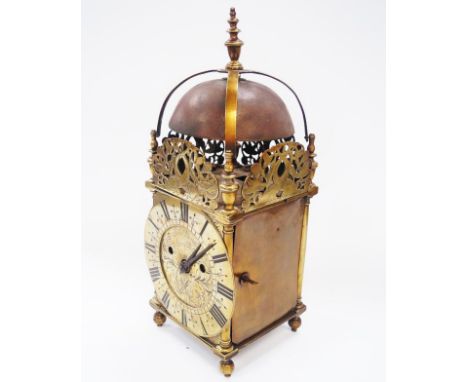 A brass lantern clock, the engraved dial plate signed John Watts Jn Stamford Fecit between entwined tulips and with steel han