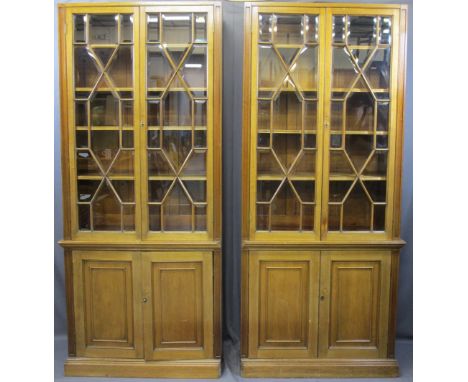 TWIN MAHOGANY GLAZED TOP BOOKCASES, 199.5cms H, 87cms W, 40cms D, both having double upper 13 pane astragal glazed doors, all