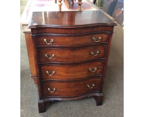 A Reproduction Mahogany Sepentine Batchelors Chest, the top hinging to reveal a mirrored and fitted compartment, raised on br