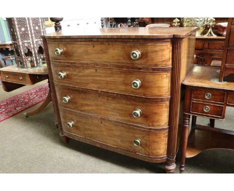 A George IV Mahogany Bow Front Chest of Four Graduated Drawers, with reeded side supports, strung inlay, brass drawer pulls a