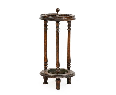 A 1920s Mahogany Whip/Stick Stand, of circular form with turned supports, 31cm diameter by 62cm high