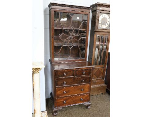 An Edwaridian Mahogany Glazed Bookcase, raised on a small chest of two short over three long drawers, and supported on ball a