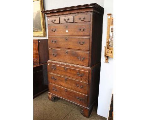A George II Oak Chest on Chest, with brass inlay, original ormalu handles and oak drawer linings and raised on open fret carv