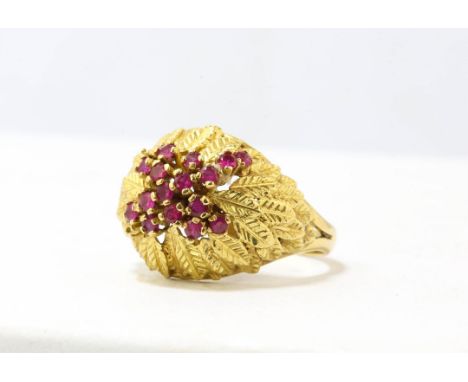 Ruby set bombe ring, leaf motif set with 16 round rubies, claw set to the centre, estimated total ruby weight 0.30 carats, mo