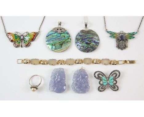 A collection of silver and costume jewellery including two lavender jade pendants, with a silver bale, two shell pendants, a 