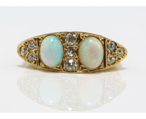 An antique opal and diamond half hoop ring, with three oval cabochon cut opals weighing an estimated total of 1.50 carats, an