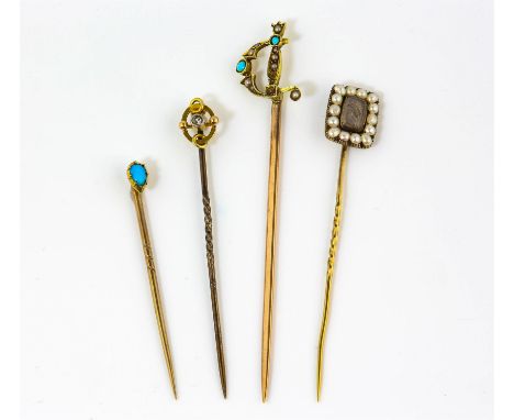 Four antique stick pins, including a mourning stick pin with a clear panel of plaited hair and a seed pearl surround in 9 ct,