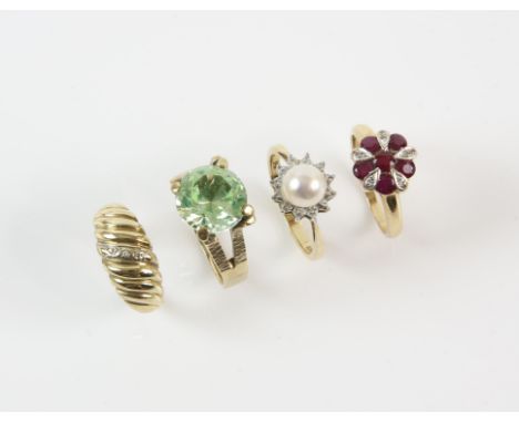 Four gem set rings including a pearl ring with a surround of diamonds, a large claw set apatite ring, a ruby and diamond flor