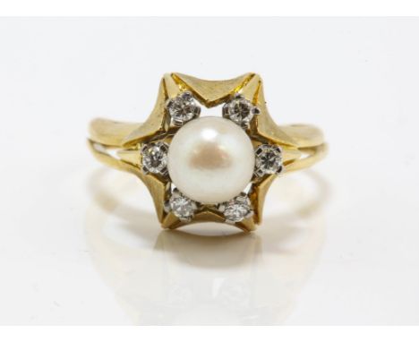 Pearl and diamond ring, set with a 7mm cultured pearl, surrounded by six round brilliant cut diamonds, weighing an estimated 