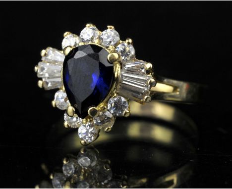 AMENDED DESCRIPTION Synthetic sapphire and diamond dress ring, central pear cut sapphire weighing an estimated 1.09 carats, w