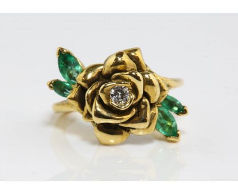 Emerald and diamond rose ring, with a central round brilliant cut diamond weighing an estimated 0.10 carat, with four marquis