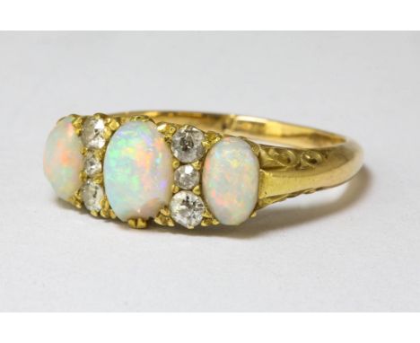 Edwardian opal and diamond ring, three oval cabochon cut opals, alternately set with old cut diamonds, estimated total diamon