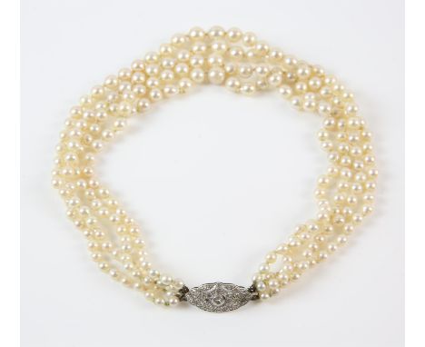 Art Deco four strand pearl collar necklace, cream pearls graduating from 4.2mm to 7.3mm in diameter, strung with knots, with 