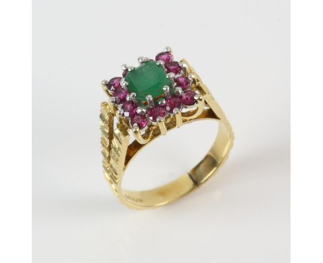 A emerald and ruby cluster ring, central emerald cut emerald weighing an estimated 1.01 carats, with a surround of round cut 