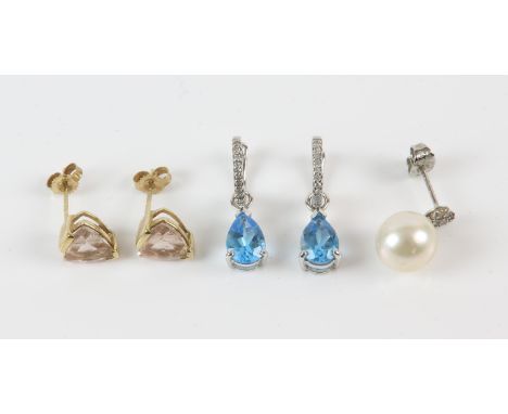 Two pairs of earrings including a pair of diamond half hoops with a removable blue topaz drop, a pair of pink topaz studs, to