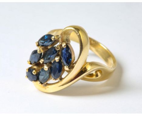 Asymmetric sapphire set ring, six marquise cut sapphires and one round cut sapphire claw set in a floral motif, estimated tot