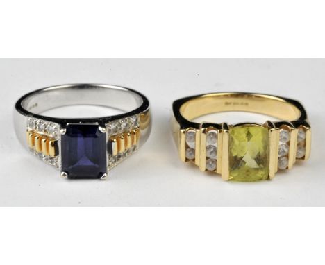 Two gem set rings, a peridot and white sapphire ring, with central mixed cut peridot flanked by two tiers of round cut white 