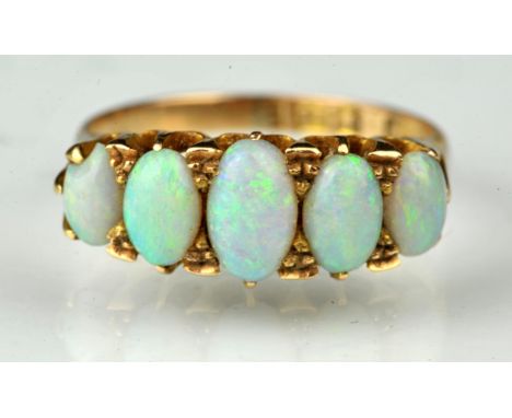 Opal five stone ring, set with graduating oval cabochon cut opals, largest measuring 6.5 x 3.8mm, claw set in 18 ct yellow go