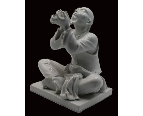 A Meissen 20th century blanc de chine figure of 'Schneider Wibble', modelled by Alexander Struck, the Chinese tailor seated c
