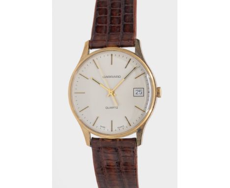 A gentleman's vintage 9ct gold cased Garrard quartz wristwatch, comprising a signed silvered dial with applied baton markers,