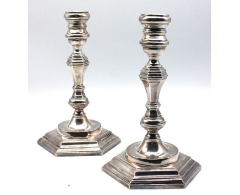 A pair of Elizabeth II Irish silver candlesticks, with hexagonal knopped stem holding circular sconce, all upon stepped hexag