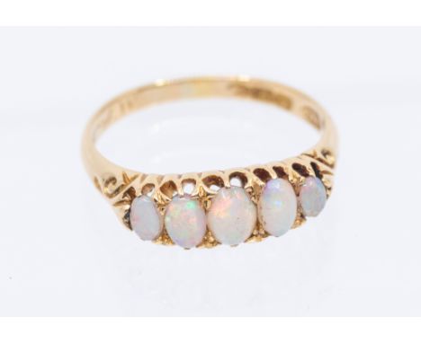 An opal and 18ct gold five stone ring, claw set with graduated oval cabochon cut opals, width approx 5mm, size O, total gross
