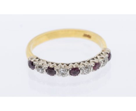 A ruby and diamond 18ct gold nine stone eternity ring, comprising a row of round mixed cut rubies and brilliant cut diamonds,