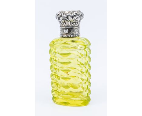 A late 19th century vaseline cut glass scent bottle, with scrolled unmarked white metal cover with shield cartouche and push 
