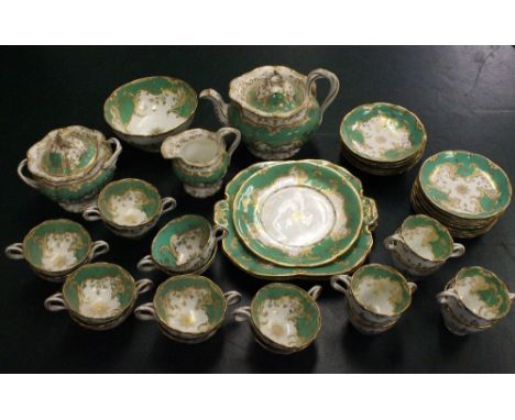 A 19th century Minton part tea service in elaborate gilt scrolled design to green and white ground, consisting of tea pot, li