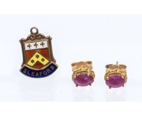 A pair of ruby and 9ct gold stud earrings, comprising oval mixed cut rubies approx 6x3mm, within a rope border, post and scro