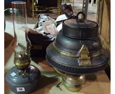 A 20th century hanging oil lamp and a military oil lamp reservoir, (2). 