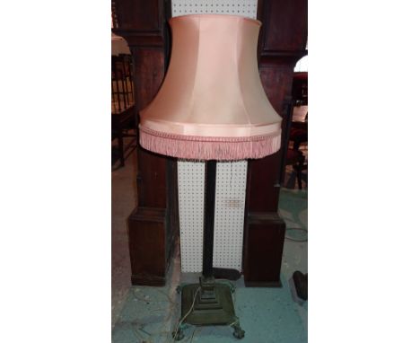 An early 20th century brass standard lamp on stepped base with claw feet, 136cm high. 