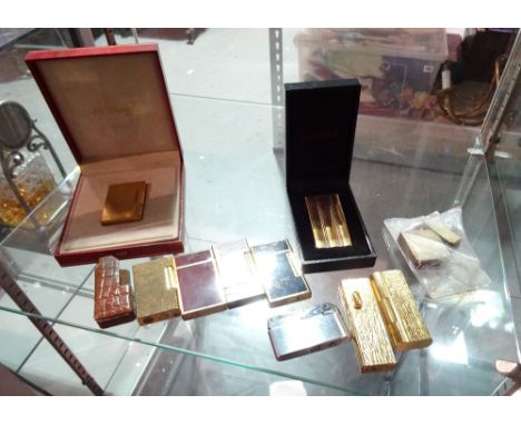 Lighters, including; gold plated St Dupont lighter, cased, a gold plated 5th Avenue lighter, cased, a gold plated Dunhill bar