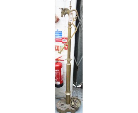 A set of Edwardian brass butcher's scales, with a bull's head terminal over a circular tapering column and shaped base, with 