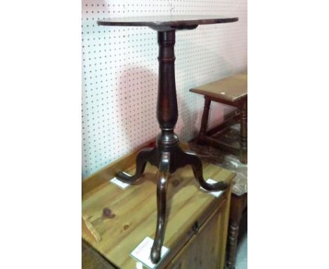 A George III mahogany tripod table with circular top on baluster column, 43cm diameter.