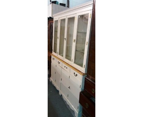 A 20th century grey painted bookcase cabinet with glazed top section over four cupboards, 124cm wide. 