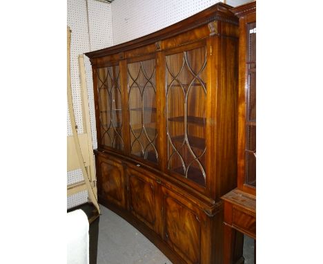 A Regency style mahogany bowfront bookcase cabinet, 178cm wide x 181cm high. 