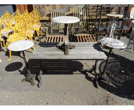 Garden furniture, comprising; a 20th century hardwood side table with cast iron legs and three cast iron tripod tables with m